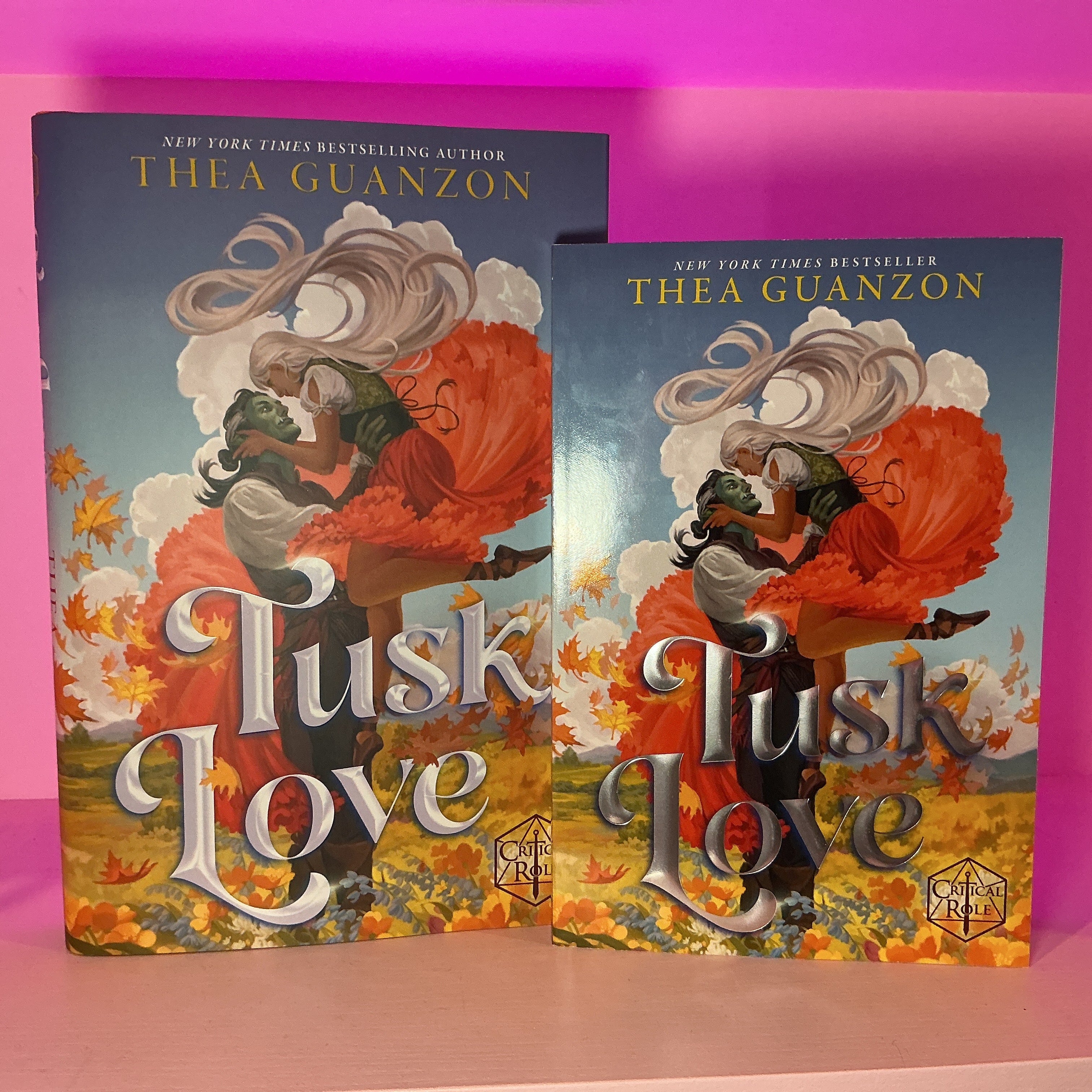 Two copies of 'Tusk Love' by Thea Guanzon on a pink background